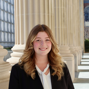 Abby's headshot, taken outside at Yale.