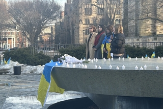 Students outside with Ukranian flag holding vigil