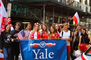 Yale polish club holding a banner.